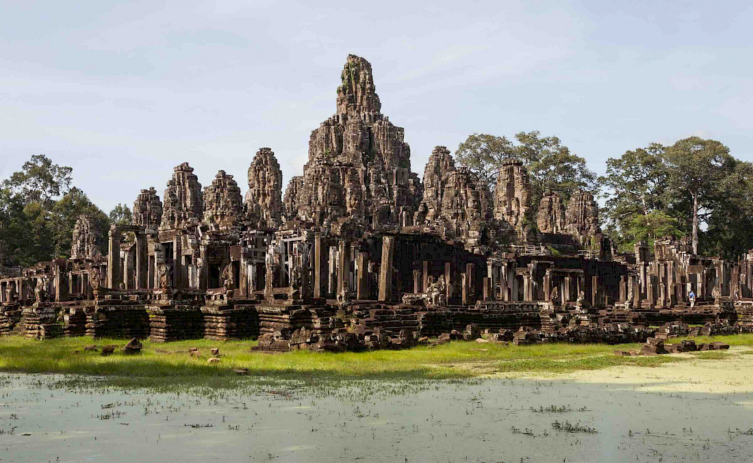 The Bayon's most distinctive feature is the multitude of serene and smiling stone faces of Brahma - probably modeled on the face of King Jayavarman VII - on every side the many towers that jut out from the upper terrace and cluster around its central peak.